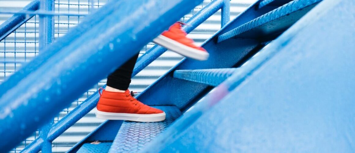 Person stepping on blue stairs